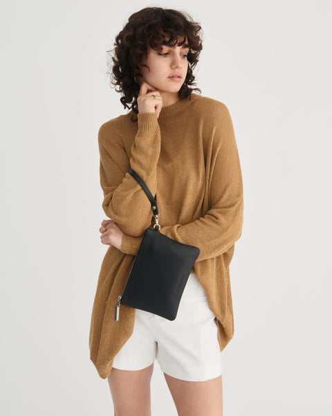 Black leather clutch with a wrist strap.