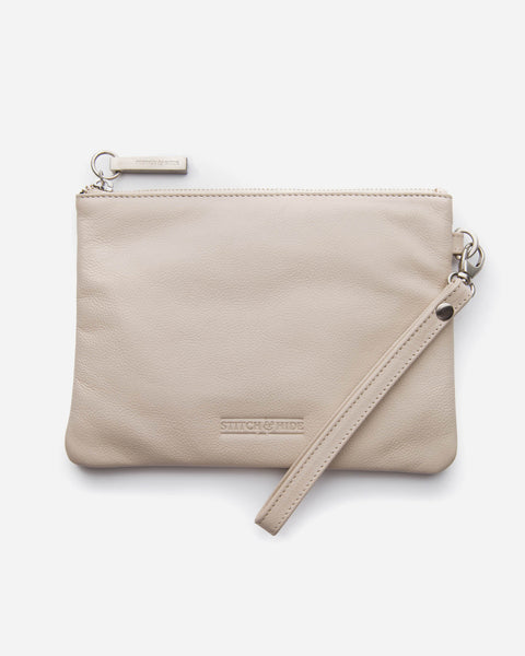Warm white leather clutch with a wrist strap.